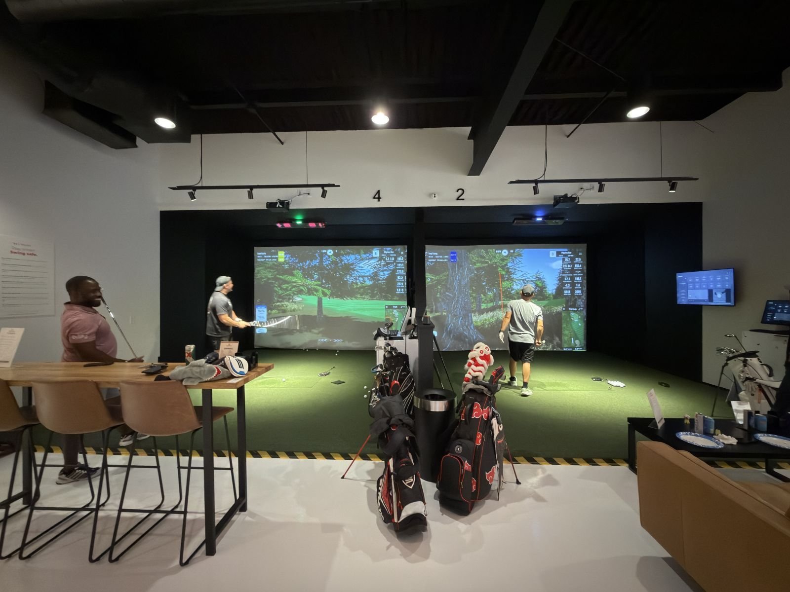 League night on the main floor, golfers at the open bays